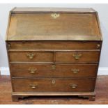 George III stained oak bureau, with sloped-front enclosing drawers, pigeonholes and covered well,