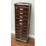 An early 20th century stained walnut ten-drawer music/filing cabinet, with hinged oak-lined drawers,