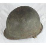 A US WWII M1 helmet with liner, straps and suspension webbing all present, and a camouflage-