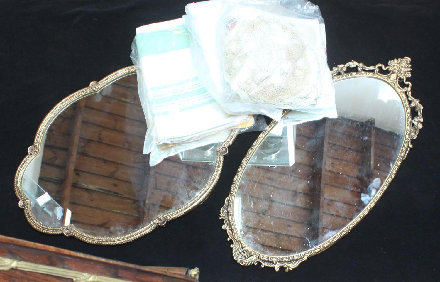 Two various gilt-metal framed oval mirrors, together with a small quantity of lace and linen