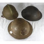 A French Fireman's helmet together with a WWII St John's Ambulance Brigade helmet and a Air Raid