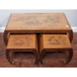 An Oriental coffee table nest with four smaller tables/stools, engraved with a scene of