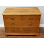 A chest of 2 short over two long graduated drawers, with brass handles, raised on bracket feet,