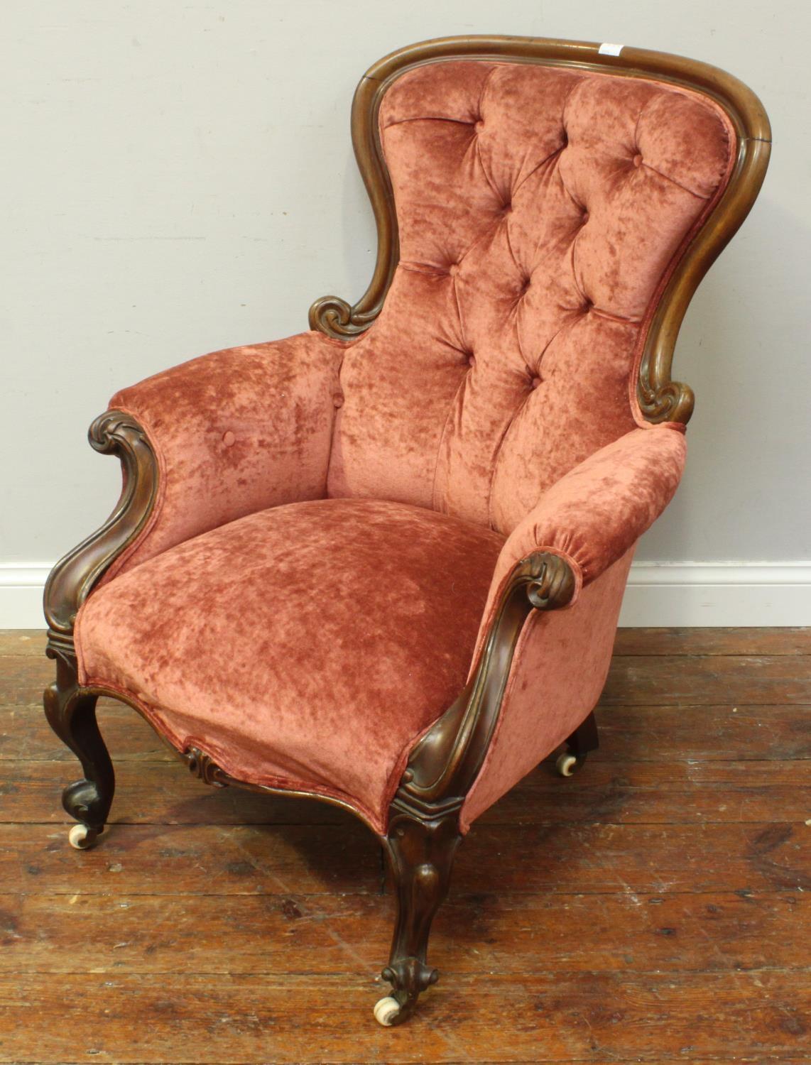 A Victorian stained walnut armchair with rouge velvet deep-button upholstery