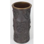 A good quality Chinese bronze vase of cylindrical form, the sides decorated with relief moulded