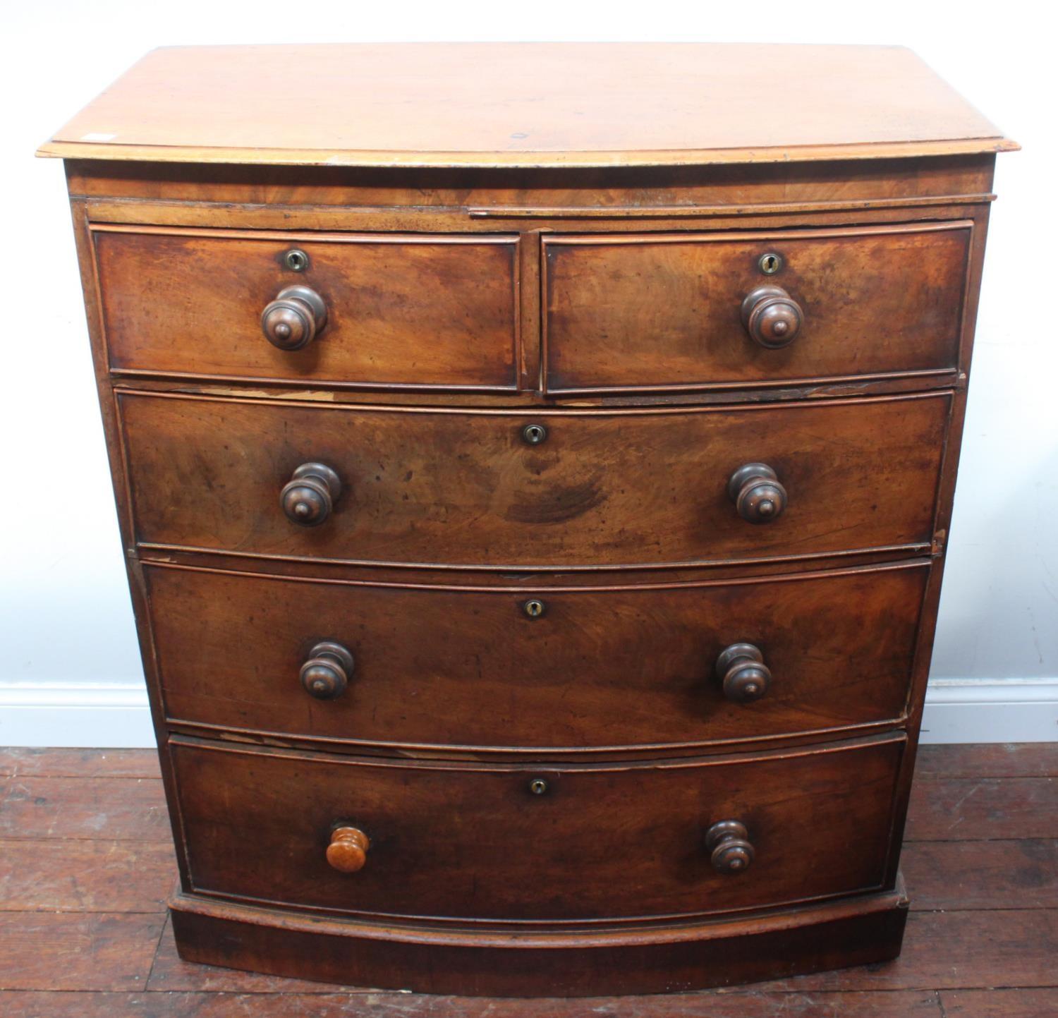 A 19th century flame mahogany bow-front chest of two short and three long graduated drawers with