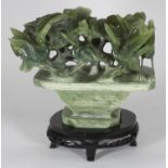 A Chinese carved soapstone figure depicting cranes amidst plants, raised on integral carved