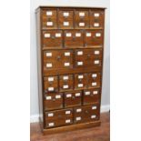 A teak 18-drawer Chinese apothecary cabinet, with two banks of three graduating drawers, each drawer