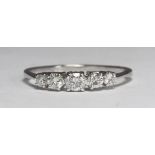 A 9ct white gold five stone diamond ring, claw-set with graduated round brilliant-cut diamonds,