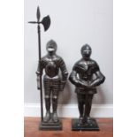 A pair of large cast metal fireside companion knights, one holding a long axe poker, the other a