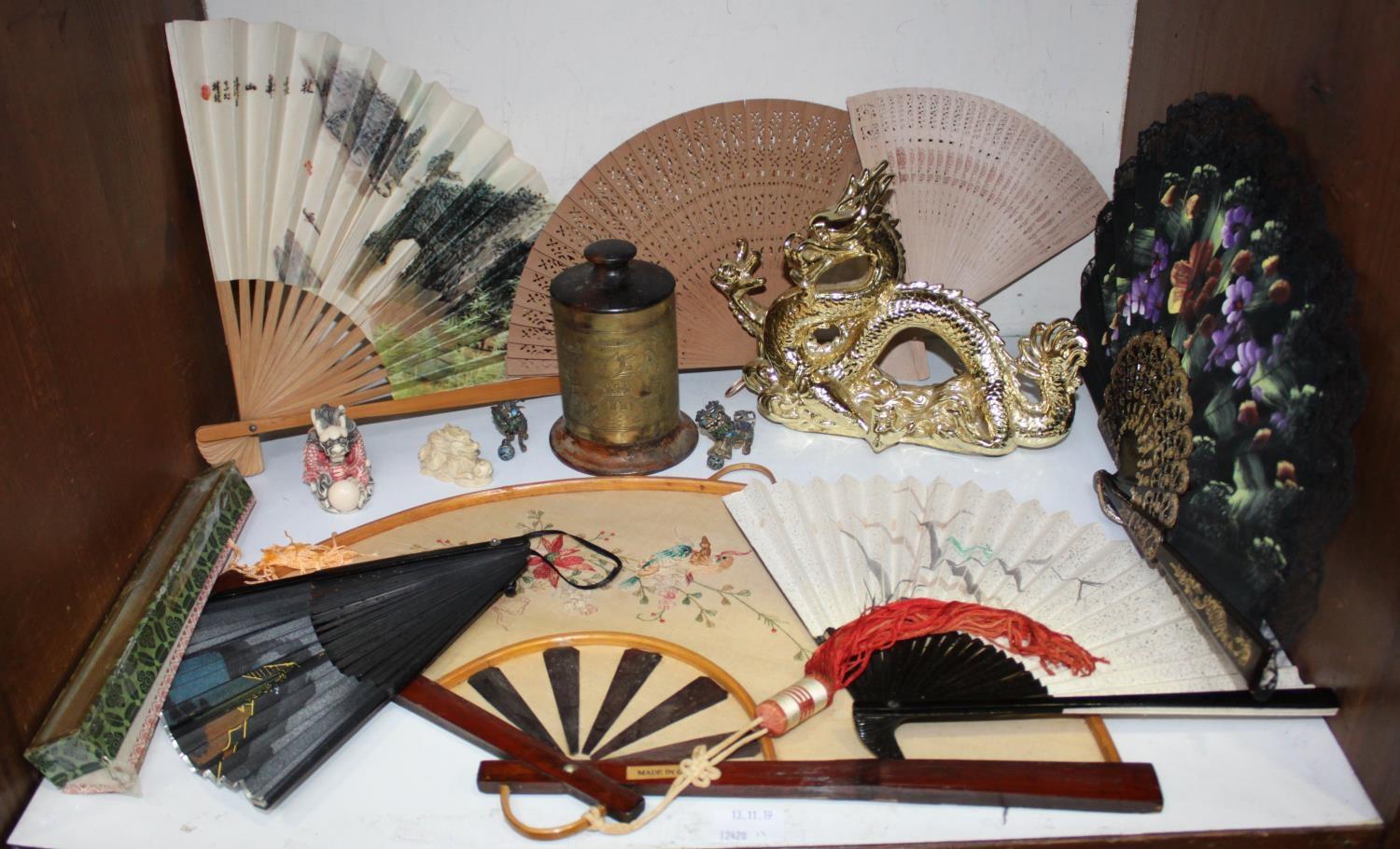 SECTION 11. Various fans together with a Chinese brass cylindrical tea caddy, gilt dragon figure and