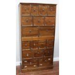 A teak 18-drawer Chinese apothecary cabinet, with two banks of three graduating drawers, each drawer