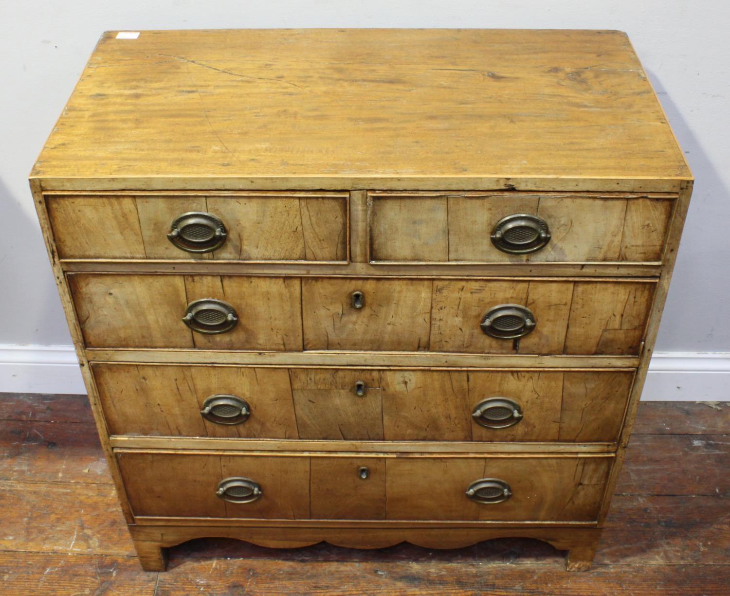 A George III faded mahogany small chest of 2 short and three long drawers, on shaped bracket feet,