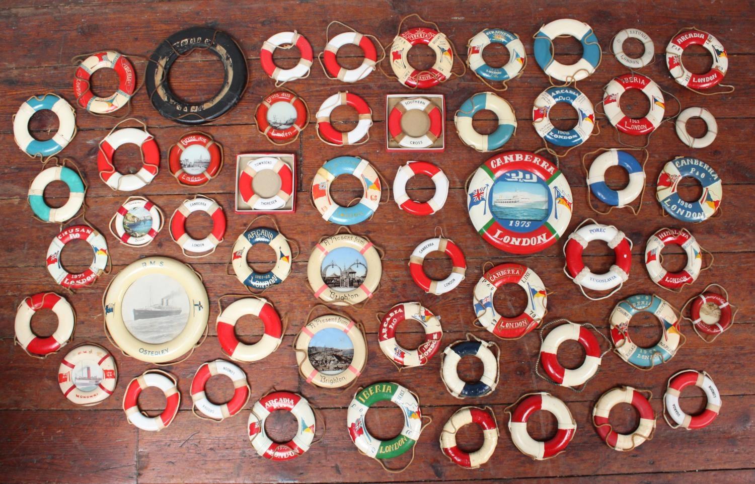 A collection of approximately 82 miniature and commemorative lifebuoys, named examples include HMS