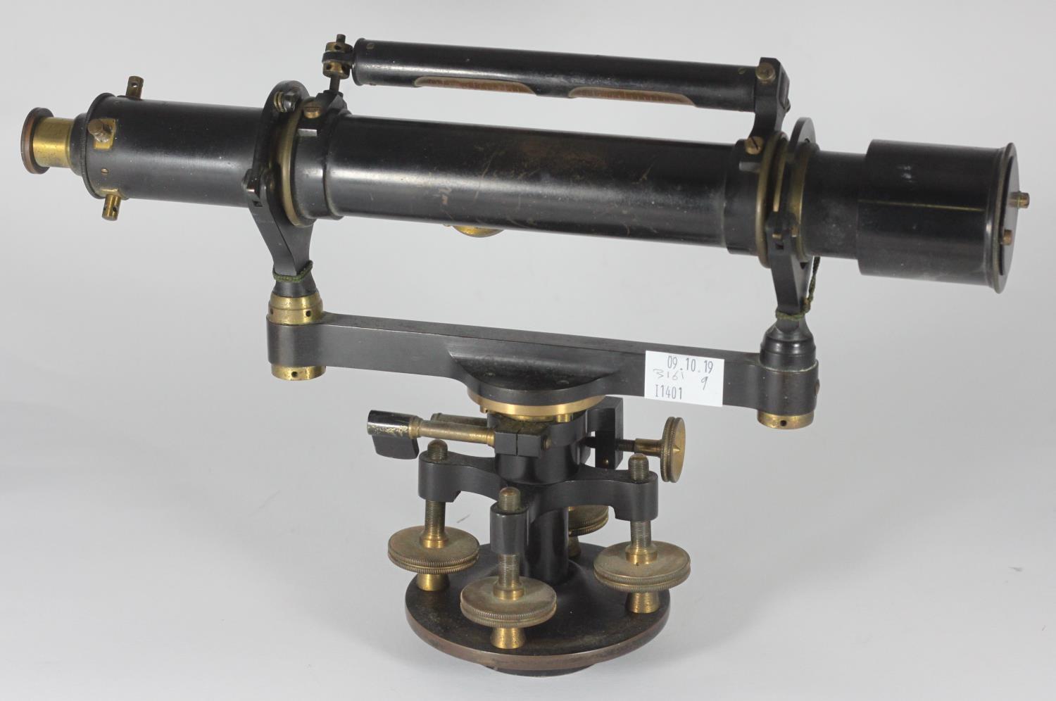 A late 19th/early 20th century black lacquered and brass surveyors level by Troughton & Simms
