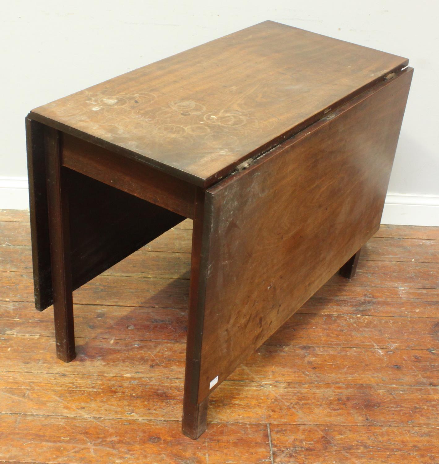 A George III stained mahogany rectangular gate-leg dining table, with two hinged leaves, chamfered