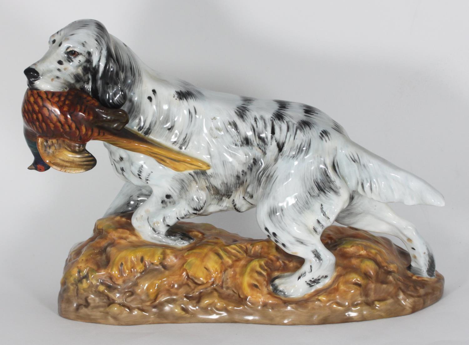 A Royal Doulton figure modelled as an English Setter with a Pheasant, raised on naturalistic