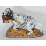 A Royal Doulton figure modelled as an English Setter with a Pheasant, raised on naturalistic