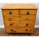 A 19th century pine chest of two short and three long graduated drawers, original turned pulls and