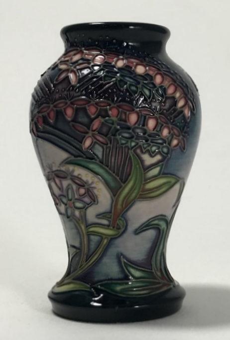 A small Moorcroft pottery vase of inverted baluster form and decorated in the 'Gypsy' pattern