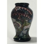 A small Moorcroft pottery vase of inverted baluster form and decorated in the 'Gypsy' pattern