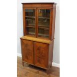 An Edwardian satinwood and burr-wood bookcase in the Sheraton Revival style, with a pair of glazed