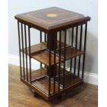 Addendum - A modern mahogany and inlaid satinwood revolving bookcase with eight divisions and sla