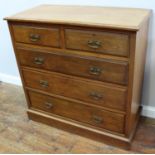 An Edwardian walnut chest of two short and three long drawers with original brass handles, 105cm