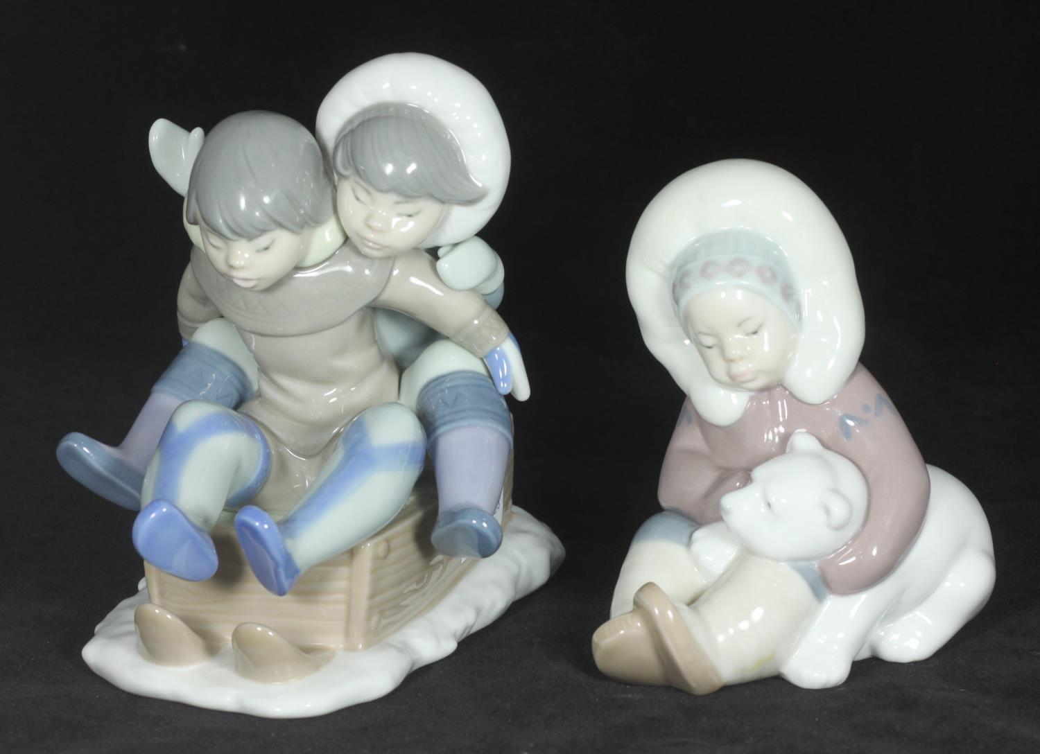 A Lladro porcelain figurine of two children sledging 'Hang On', No. 5665, together with a Lladro