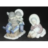 A Lladro porcelain figurine of two children sledging 'Hang On', No. 5665, together with a Lladro