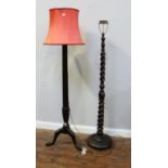 A 19th century stained mahogany standard lamp with fluted and reeded column, leaf-carved tripod