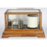 An early 20th century oak-cased aneroid barograph, with under-drawer, charts