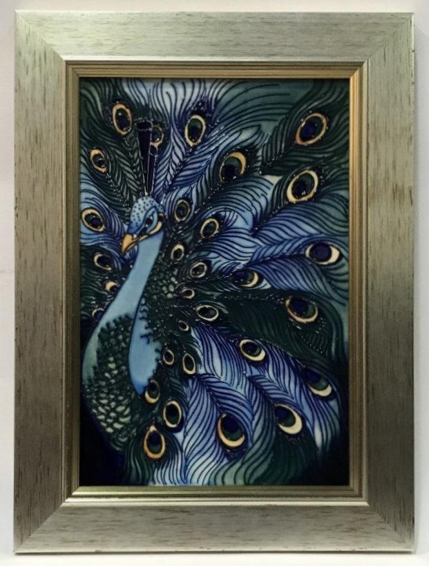 A Limited edition Moorcroft plaque decorated with a peacock after a Rachel Bishop design, 146/200,