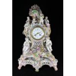 A 19th Century German porcelain clock garniture, in the Rococo revival style, with French eight-