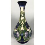 A limited edition Moorcroft pottery vase, of onion form and decorated in the 'Wolfsbane' pattern