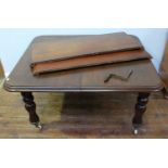 A 19th century stained mahogany winding-extending dining table, of rectangular form with two extra