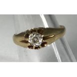 A yellow metal (tests as 14ct gold or above) gents ring, the top centrally claw set with a round,