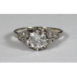 A platinum diamond ring, centrally claw set with a round, transitional cut diamond, total diamond