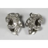 A pair of 14ct white gold clip-on earrings, of spray design, set with a total of one carat of