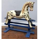 A child's carved and painted wooden rocking horse, dapple, with blue wooden stand, embossed