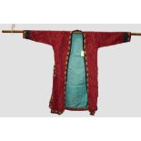 Turkmen red silk striped and embroidered coat, second half 20th century, 24in., 61cm. Underarm