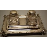 A late Victorian silver rectangular partners inkstand, with two pen wells and hooped frames for a
