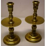 A pair of Dutch mid seventeenth century brass candlesticks, the baluster turned stems with girdle