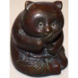 A Chinese bronze panda, eating bamboo shoots, 3.1in (8cm) probably late nineteenth century.