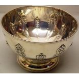 An Edwardian silver rose bowl, the sides with hugenot style repousse ribs, on a moulded foot, 8in (