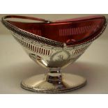 A George III oval silver swing handle sweetmeat basket, the pierced sides engraved with patterned