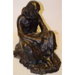 An Irish bronze sculpture of a weary friar, seated on a bank, inscribed Dailey (possibly late