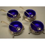 A set of four Victorian silver salts, the sides with repousse foliage and a crested cartouche,