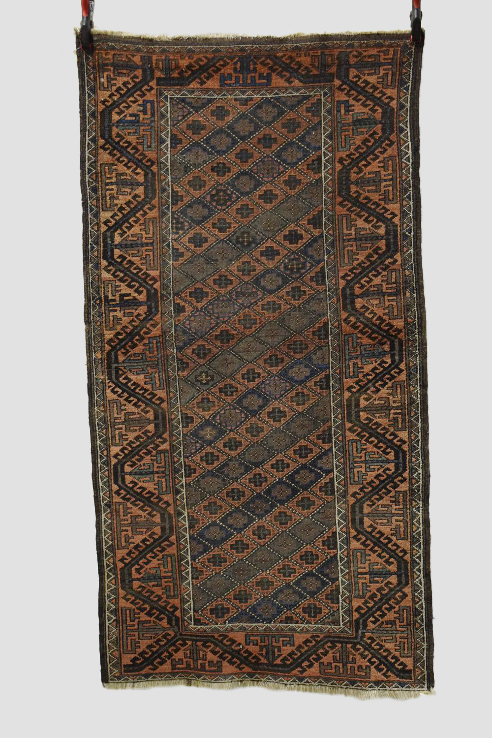 Two Baluchi rugs, Khorasan, north east Persia, the first a long rug of lattice design, early 20th