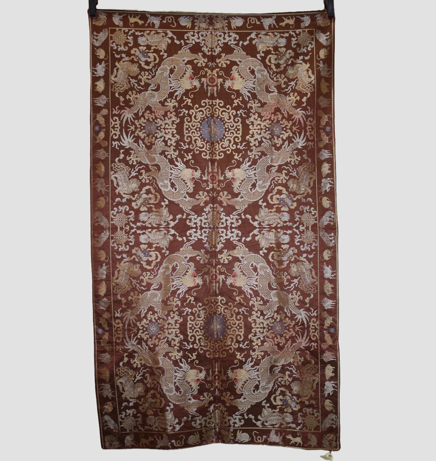 Chinese silk damask hanging, 20th century, 66in. x 37in. 168cm. x 94cm. The chestnut ground woven